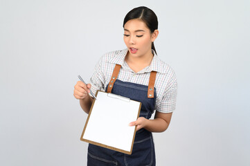 Portrait of young asian woman in waitress uniform pose with clipboard