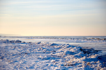 Winter landscape with icy sea coast and calm blue sky, selective focus