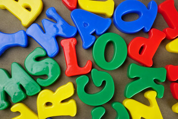 Set of colorful plastic alphabets isolated on background.