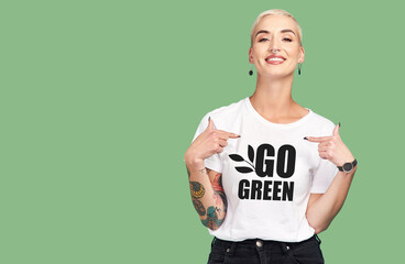 Mockup, sustainable fashion and green background, woman with tshirt and space for eco friendly...