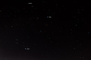 Summer triangle (Deneb, Vega, Altair) in dark night sky. Stellar summer triangle consisting of the...