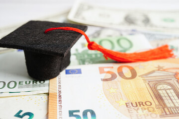 Graduation gap hat on Euro and US dollar banknotes money, Education study fee learning teach...
