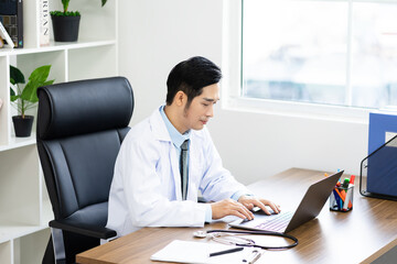 Fototapeta premium Asian male doctor portrait sitting at work