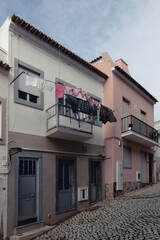 washed clothes are dried on a rope on a narrow street of the old town