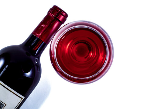 A Glass And A Bottle Of Red Wine On A White Background. View From Above.