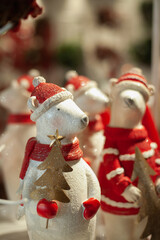 White bear ornament with Santa outfit. Winter holiday season decoration. Vintage decor at Xmas market.
