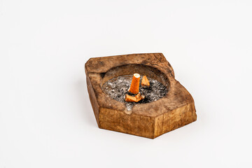 Cigarette butt in an ashtray. the white background