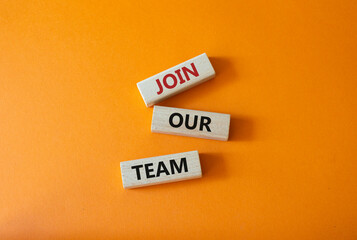 Join our team symbol. Wooden blocks with words Join our team. Beautiful orange background. Business and Join our team concept. Copy space.