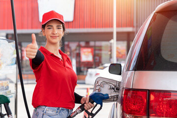 Attendant service female worker refuelling car at gas station. Assistant woman worker wear red...