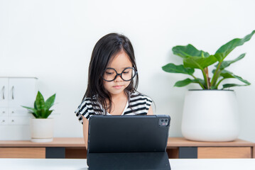 Asian child girl student wow excited on video call learning to studying online class or person learn from home school with tablet