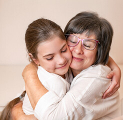 grandmother hugging her granddaughter close-up