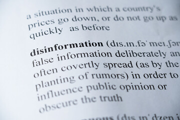 Fototapeta premium A mock up of a dictionary page with the word Disinformation with selective focussing