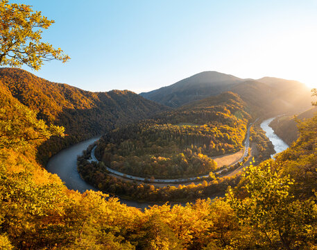 View of autumn scenery of Domasinsky meander illuminated with sunset light in Zilina region, Slovakia. The Vah River flows past autumn forests in a U-shape