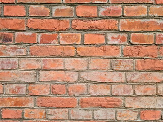 An old red brick wall. Historical horizontal brickwork for wallpaper and surface design. Brick pattern.