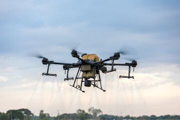 Modern smart farm with drone. Agriculture drone fly to Ready spray fertilizer on the rice fields.