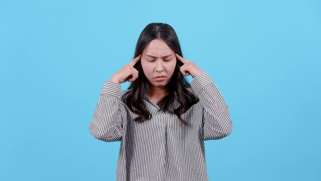 4K, portrait, woman with long hair wearing striped shirt, use index finger poke down temples both sides head, contemplating something, with serious face, Isolated indoor studio on blue background.