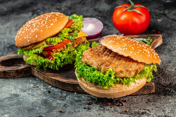 Tasty grilled home made burgers with beef, tomato, cheese, and lettuce. fast food and junk food concept