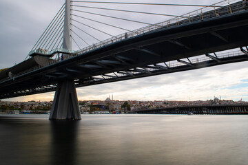 Fototapeta na wymiar Long exposure. View of Haliç Metro Bridge connecting Azapkapı (Beyoğlu) and Unkapanı (Fatih) (Halic Metro Bridge). blue sky Istanbul Turkey