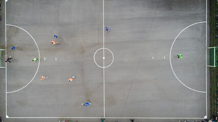 top view drone flying above amateur soccer game match. Countryside authentic tournament. 