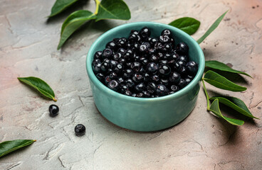 Superfoods antioxidant of indian mapuche. Bowl of fresh maqui berry on light background, top view