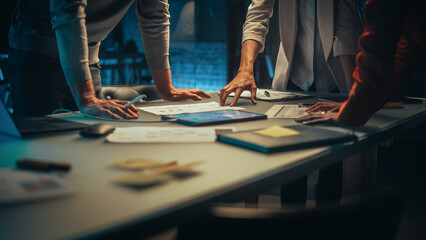 Close Up on Colleagues Discussing a New Business Opportunity, Putting Hands on a Meeting Room Table in an Office at Night. Discussing Project Plan on Tablet Computer with Development Timeline