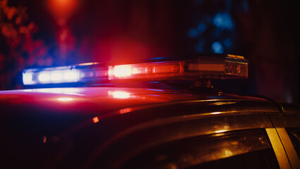 Close-up Shot of Police Car Siren Lights. Offices of the Law Ready for Action, Chase the Criminals, Arrest Offenders and Fight Crime. Stylish Cinematic Lights with Dark Sky © Gorodenkoff