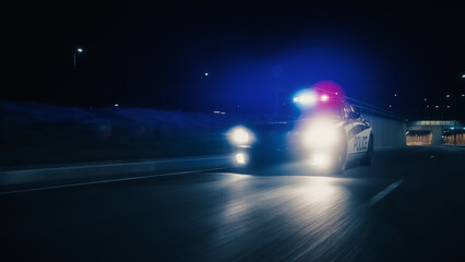Traffic Patrol Car In Pursuit, Driving Fast with Sirens Blazing through the City Tunnel. Officers of the Law Chasing a Suspect. Cops in Squad Car React to Emergency Call. Cinematic Night Shot © Gorodenkoff