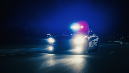 Traffic Patrol Car In Pursuit, Driving Fast with Sirens Blazing through the City Streets. Officers of the Law Chasing a Suspect. Cops in Squad Car React to Emergency Call. Cinematic Night Shot © Gorodenkoff