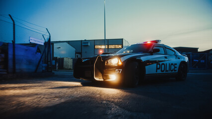 Traffic Patrol Car in Pursuit. Police Officers in Squad Car Chasing Suspect on Industrial Road, Sirens Blazing, High Speed. Cops on Emergency Response Call. Stylish Cinematic Action © Gorodenkoff