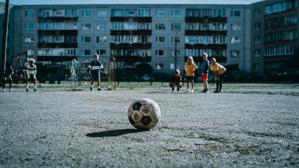 Happy Multicultural Diverse Friends Playing Soccer in Their Backyard on a Sunny Day in Summer. Cheerful Boys and Girls Celebrating Scoring a Goal and Winning the Match. Cold Color Grading. © Gorodenkoff
