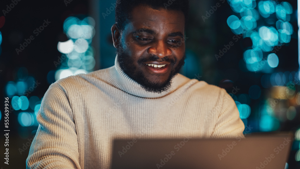 Aufkleber close up portrait of a creative project manager working on a laptop computer in an office at night. 