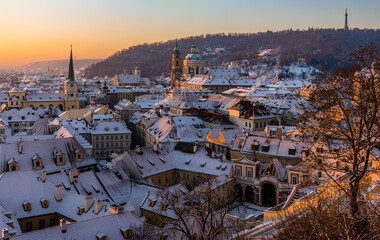 Mala Strana and St. Nicholas Church in old town of Prague covered in snow in the winter morning.