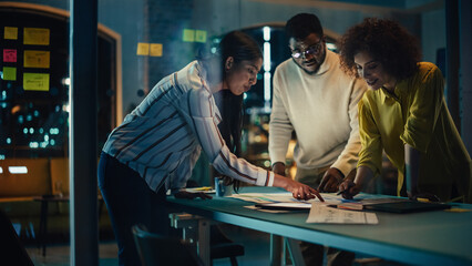 Excited Marketing Manager Leading a Team Meeting in Creative Office Conference Room in the Evening. Confident Multiethnic Female DIscussing a New Project Plan with Agency Employees.