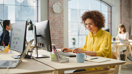 Biracial Woman Smiles Happily When Successfully Finishing a Work Project. Multiethnic Group of...