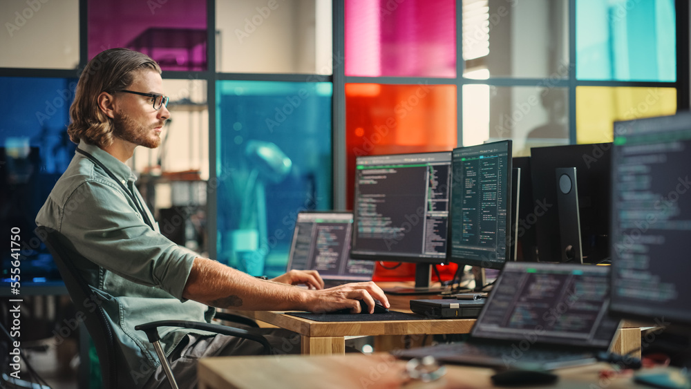 Leinwandbilder Professional Male Programmer Writing Code on Desktop Computer With Multiple Displays in Stylish Office. Caucasian Man Does Data Scraping For Artificial Intelligence Innovative Technology Start-Up.