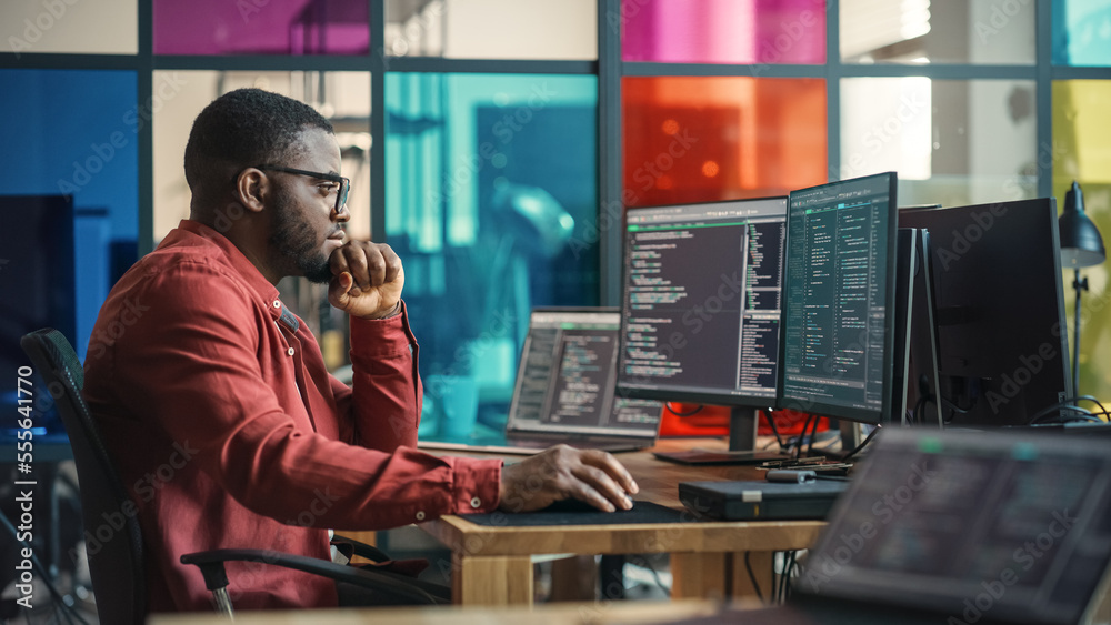Poster Male Senior Software Developer Writing Code On Desktop Computer With Two Displays Setup in Stylish Office. Black Man Working On Mobile Application For Online Service of Modern Start-up Company.