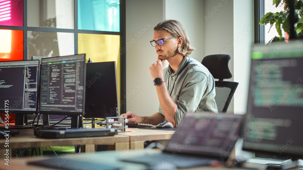 Poster Focused Caucasian Man Coding On Desktop Computer in Stylish Office Space. Male Software Engineer Developing Innovative Application For Business Customers in Technological Start-up Company.