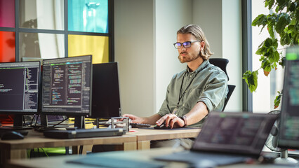 Male Data Scientist Coding on Desktop Computer in Creative Office Space. Caucasian Man Scraping...