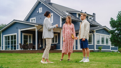 Real Estate Agent Showing a Beautiful Big House to a Young Successful Couple. People Standing...