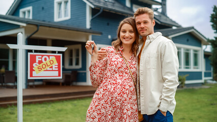 Portrait of a Beautiful Young Couple in Love Standing in Front Their New Home. Successful...