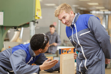 Fototapeta na wymiar two men in carpentry workshop