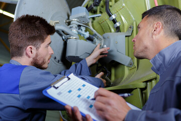engineer with apprentices checking antena