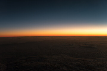 Fototapeta na wymiar Sunset above the clouds from airplane