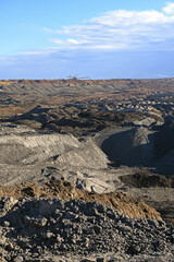 An huge excavator on a coal surface mine. Interesting geological forms of tailings dump in an open pit coal mine.