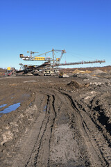 An huge excavator on a coal surface mine. Interesting geological forms of tailings dump in an open pit coal mine.
