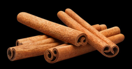 Delicious cinnamon sticks, isolated on black background