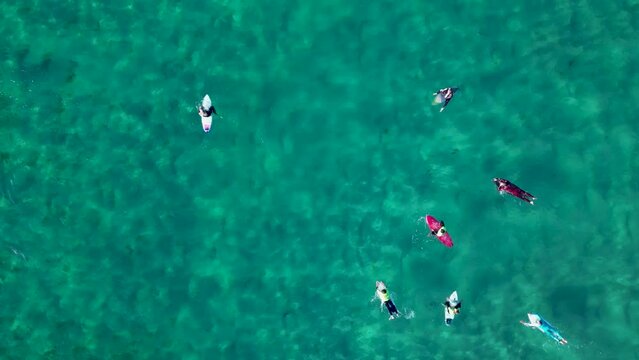 Surfers Floating With Surfboards On Pristine Water Of Caion Beach In Galicia, Spain. Aerial Topdown