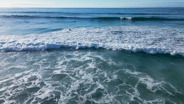 Foamy Waves Rolling With Surfers During Summer At Playa de Caion In Galicia, Spain. Aerial Shot