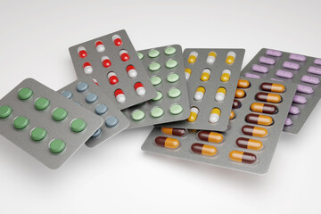 Different types of antibiotic capsules and pills in strip or blister packaging. Illustration of the concept of pharmaceutical research and drug development for cancer and other diseases