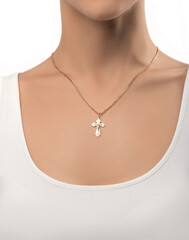 isolated on white background jewelry silver cross on a golden chain around the neck of a model girl. Front and side view of jewelry on girl